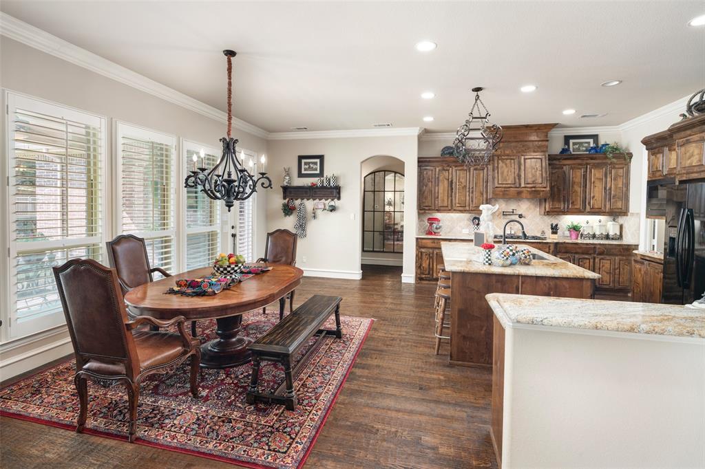 1031 Fox Bend Way Prosper, TX 75078 - Photo 13 of 40 a dining room with furniture a chandelier and wooden floor