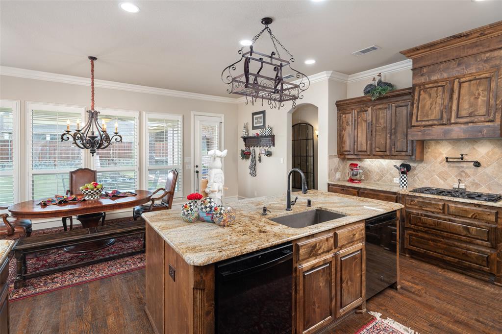 1031 Fox Bend Way Prosper, TX 75078 - Photo 17 of 40 a kitchen with stainless steel appliances granite countertop a sink stove and cabinets