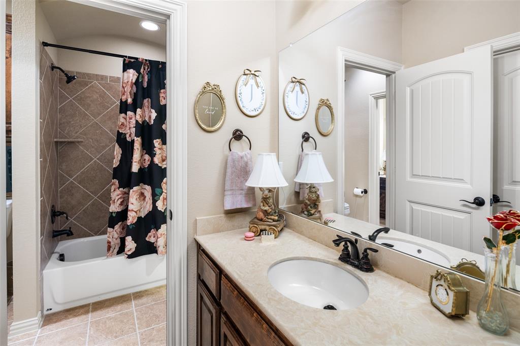 1031 Fox Bend Way Prosper, TX 75078 - Photo 25 of 40 a bathroom with a tub sink and mirror