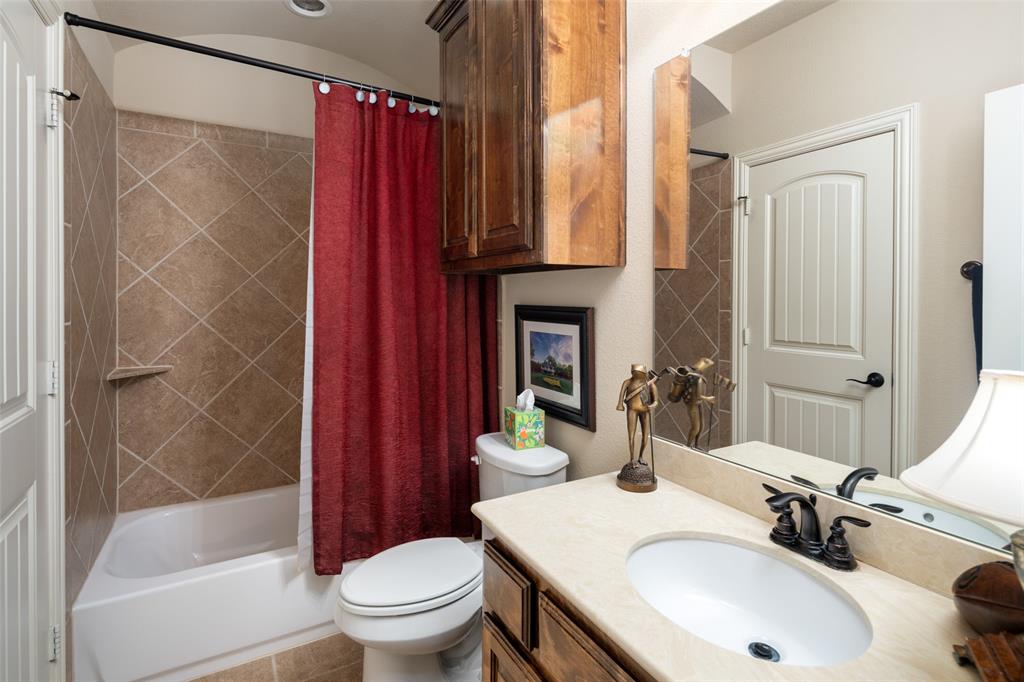 1031 Fox Bend Way Prosper, TX 75078 - Photo 27 of 40 a bathroom with a sink toilet and shower