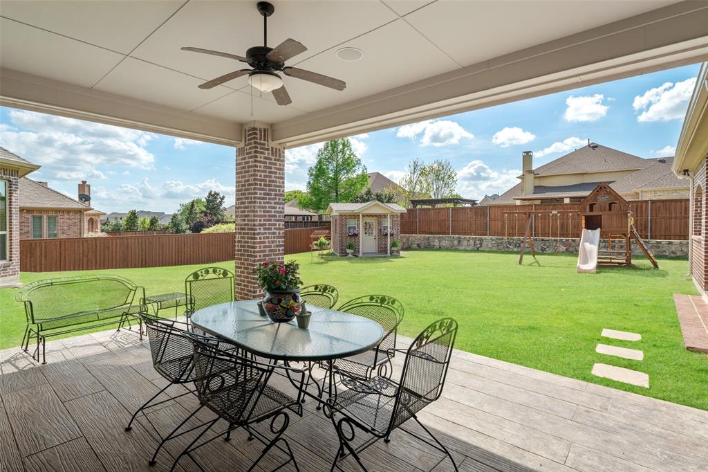 1031 Fox Bend Way Prosper, TX 75078 - Photo 28 of 40 a view of a patio with table and chairs and a garden