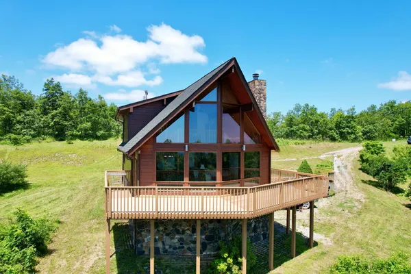a view of house with a yard and seating space