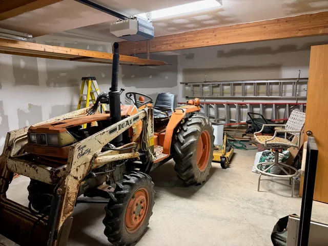a aerial view of a house with a yard and large tree