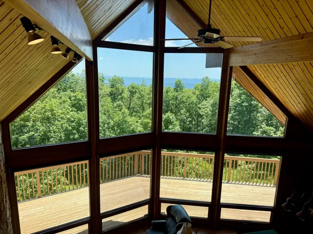a living room with furniture tv and a large window