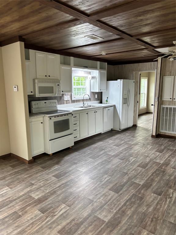 11511 Northeast 110th Road Oxford, FL 34484 - Photo 18 of 43 a kitchen with a stove a sink and white cabinets
