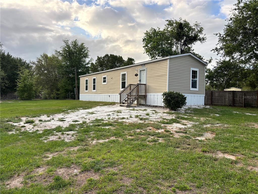 11511 Northeast 110th Road Oxford, FL 34484 - Photo 2 of 43 a view of a house with a yard