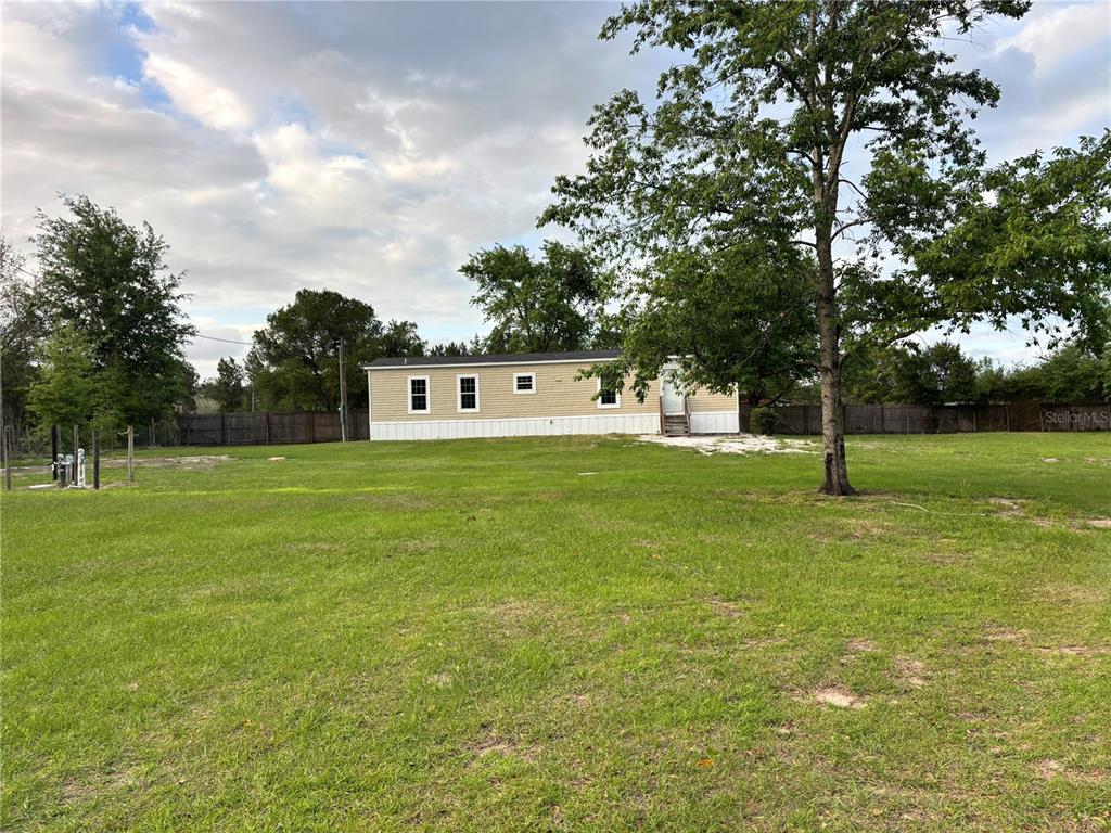 11511 Northeast 110th Road Oxford, FL 34484 - Photo 3 of 43 a view of a house with a yard