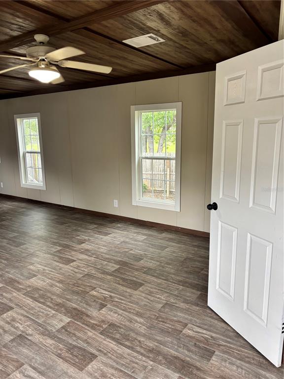 11511 Northeast 110th Road Oxford, FL 34484 - Photo 36 of 43 a view of an empty room with wooden floor and a window