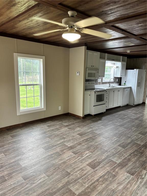 11511 Northeast 110th Road Oxford, FL 34484 - Photo 37 of 43 a view of a kitchen with a stove cabinets and a wooden floor
