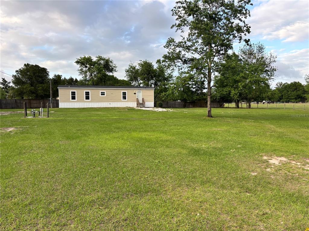 11511 Northeast 110th Road Oxford, FL 34484 - Photo 8 of 43 a house view with a play ground