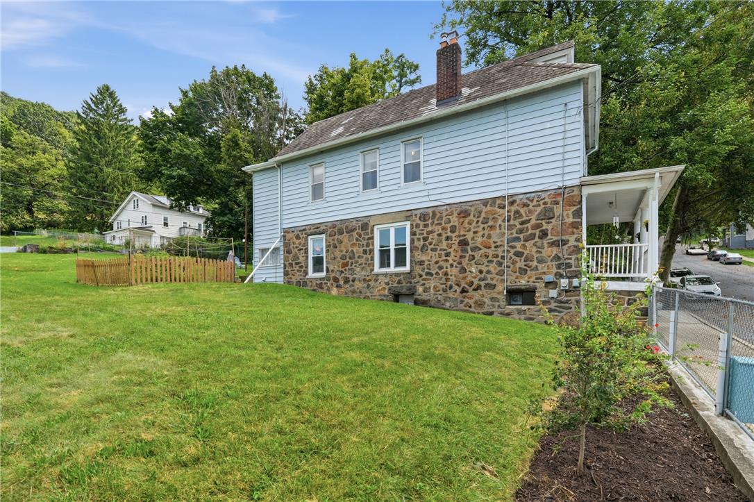 809 Hayes Street Bethlehem, PA 18015 - Photo 24 of 31 A stone and siding exterior rises above a spacious grassy side yard.