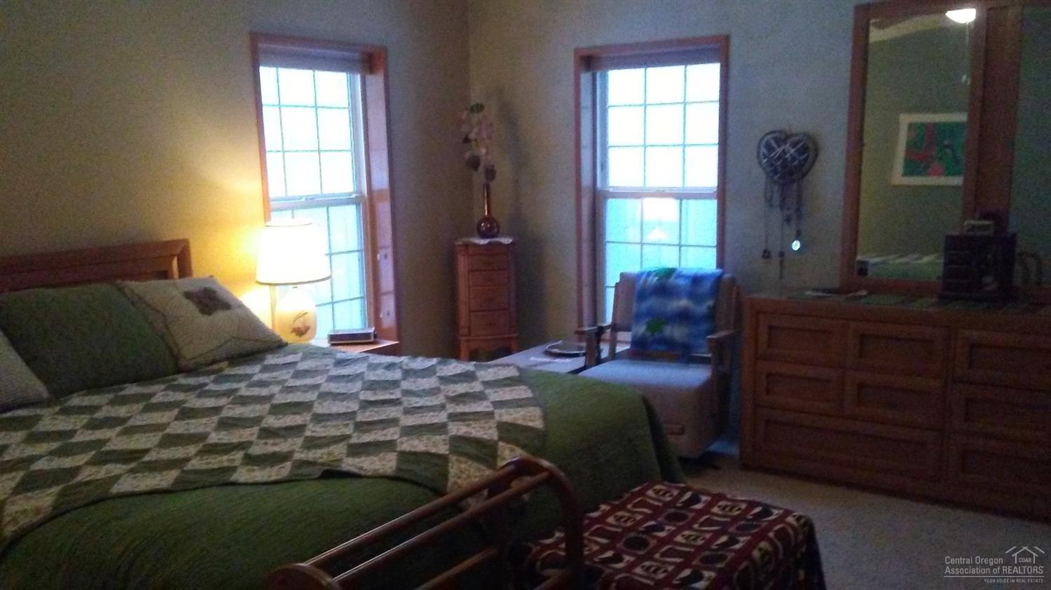 19073 Baker Road Bend, OR 97702 - Photo 12 of 14 a bedroom with a bed and a window