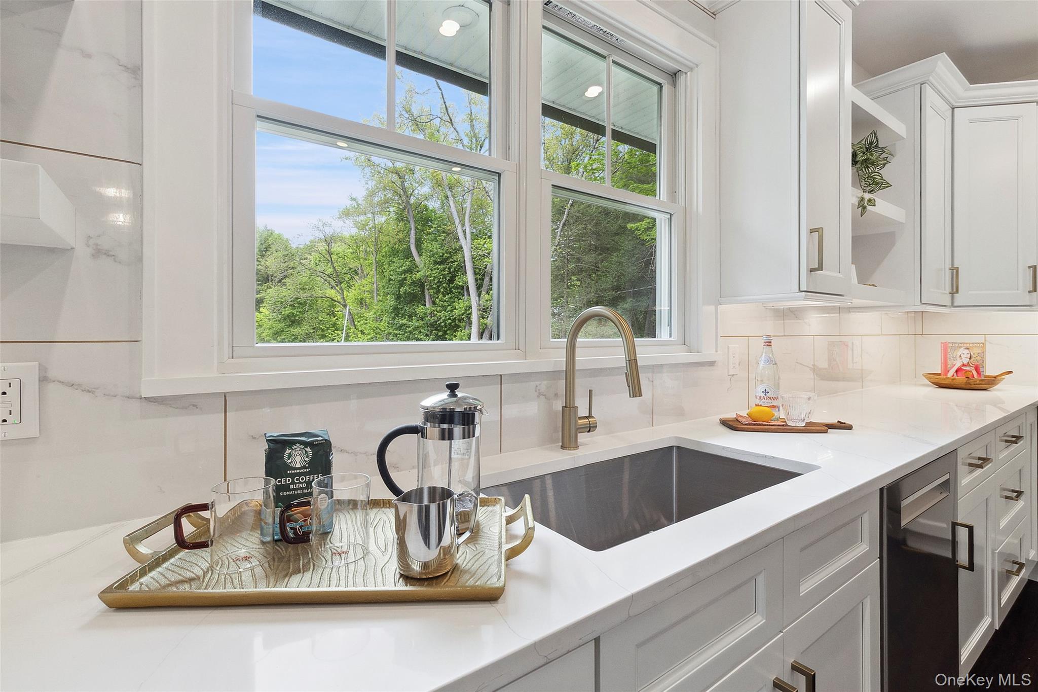 a kitchen with sink a window and cabinets