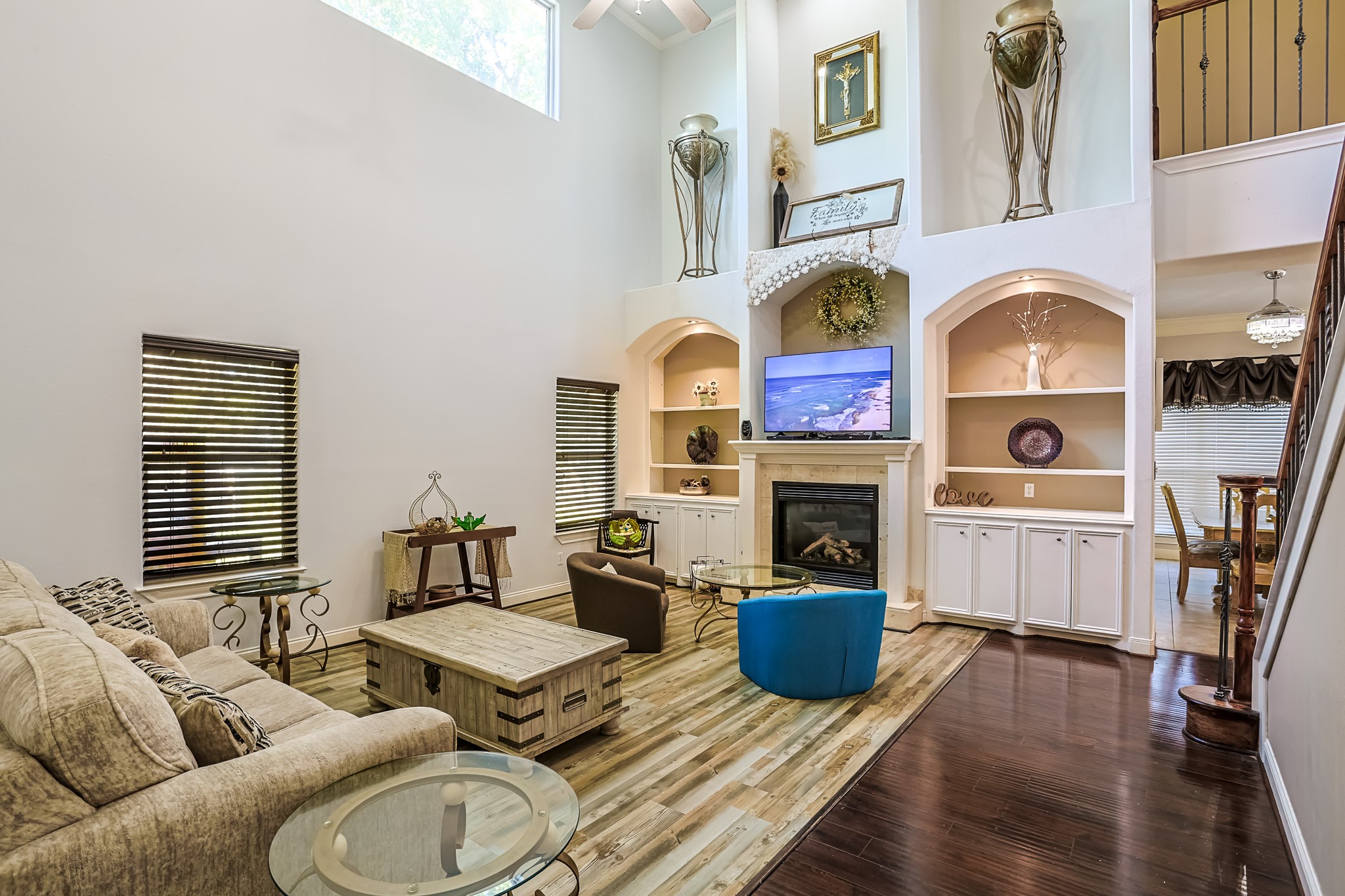 30119 West Geneva Drive Spring, TX 77386 - Photo 9 of 35 Grand living area with soaring ceilings, built-in shelving, and a statement fireplace anchoring the space with timeless charm