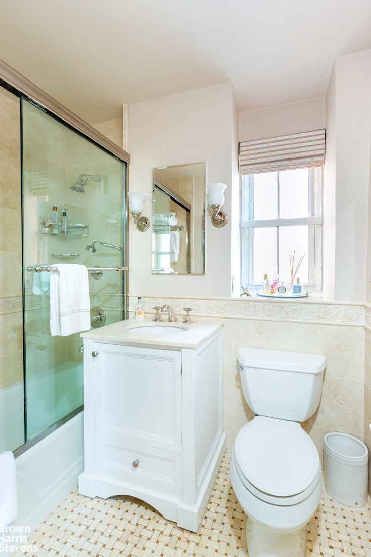 530 East 72nd Street, Unit 9B Manhattan, NY 10021 - Photo 10 of 18 a bathroom with a sink toilet and mirror