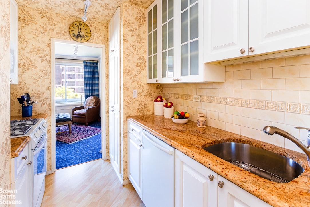 530 East 72nd Street, Unit 9B Manhattan, NY 10021 - Photo 5 of 18 a kitchen with a sink stove and cabinets