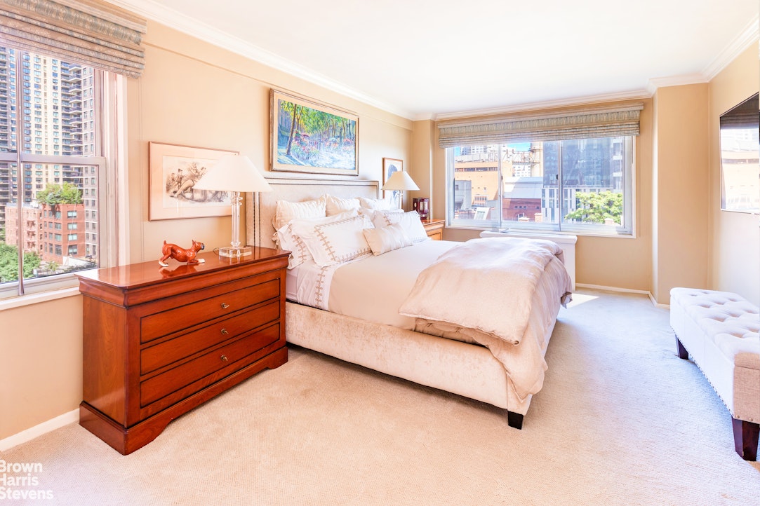 530 East 72nd Street, Unit 9B Manhattan, NY 10021 - Photo 9 of 18 a bedroom with a bed and large window