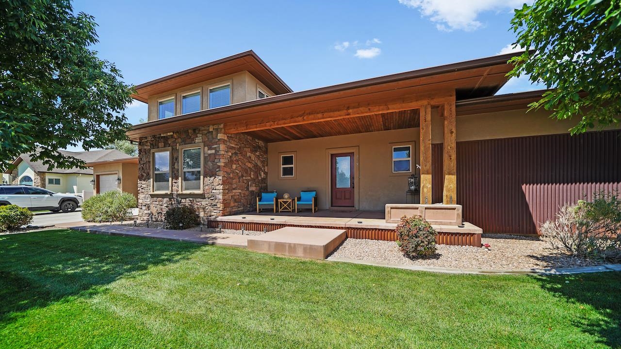 a front view of a house with patio and yard