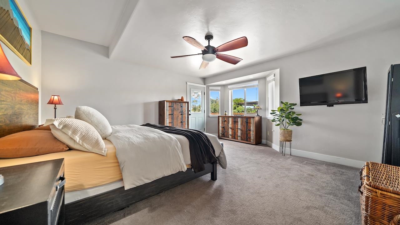 949 Kayenta Way Fruita, CO 81521 - Photo 15 of 41 a bedroom with a bed and a flat screen tv