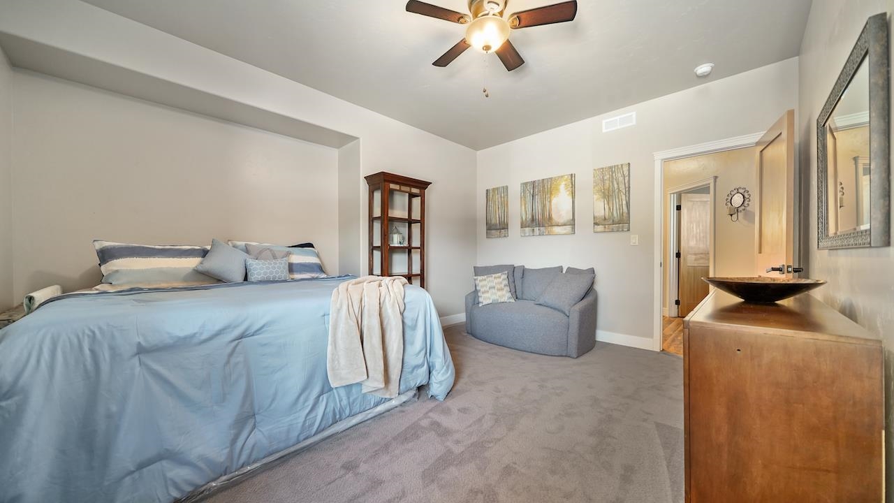 949 Kayenta Way Fruita, CO 81521 - Photo 22 of 41 a bedroom with a bed and couch