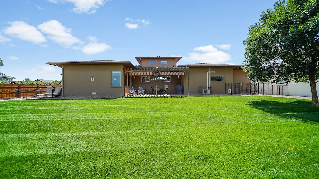 949 Kayenta Way Fruita, CO 81521 - Photo 38 of 41 a front view of a house with garden and a tree