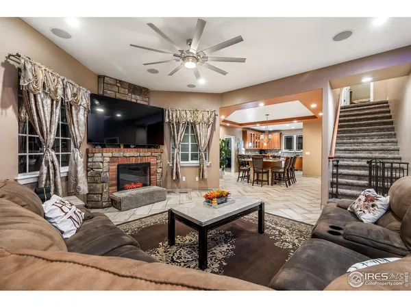 a living room with fireplace furniture and a flat screen tv