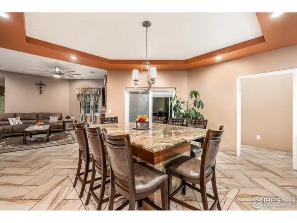 a view of a dining room with furniture and chandelier