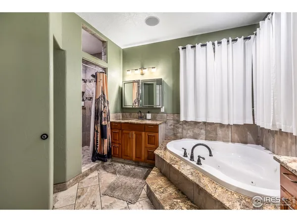 a bathroom with a bathtub sink and a mirror