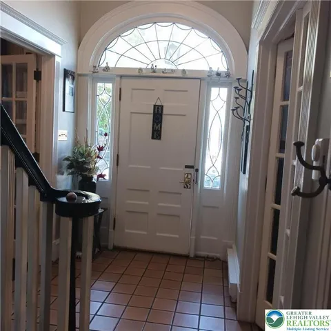 a view of a dining room with furniture and a chandelier