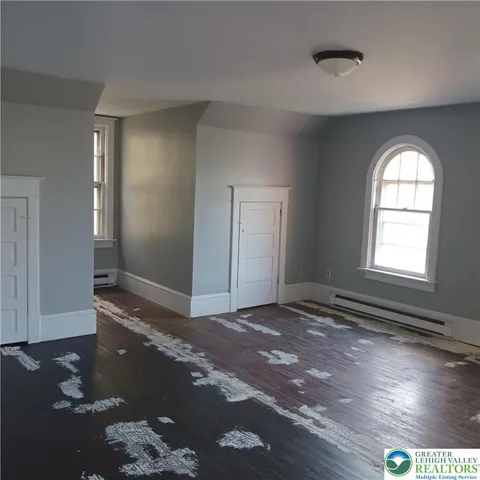 a room with gym equipment and a rug