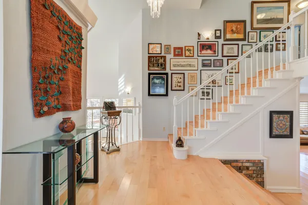 a kitchen with stainless steel appliances kitchen island granite countertop a table chairs refrigerator and microwave