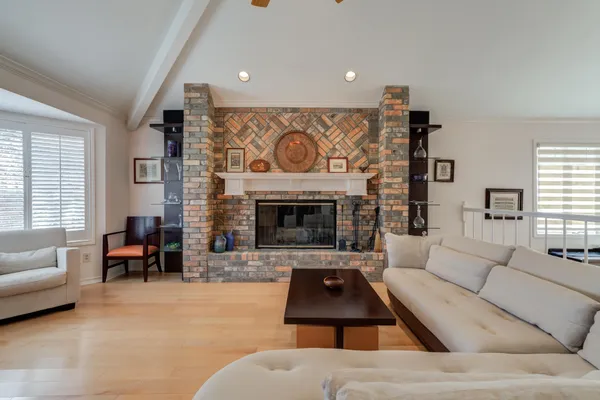 a living room with furniture and a painting on the wall