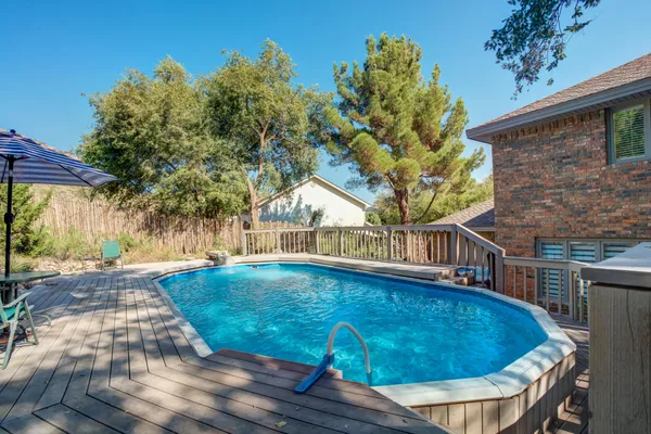 a view of a swimming pool with a patio