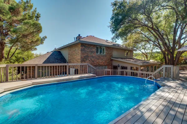 a view of a backyard with a sink and wooden fence