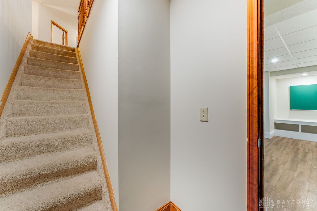 7400 Cook-Jones Road Waynesville, OH 45068 - Photo 42 of 72 This interior staircase offers a carpeted ascent to the next level of the home.