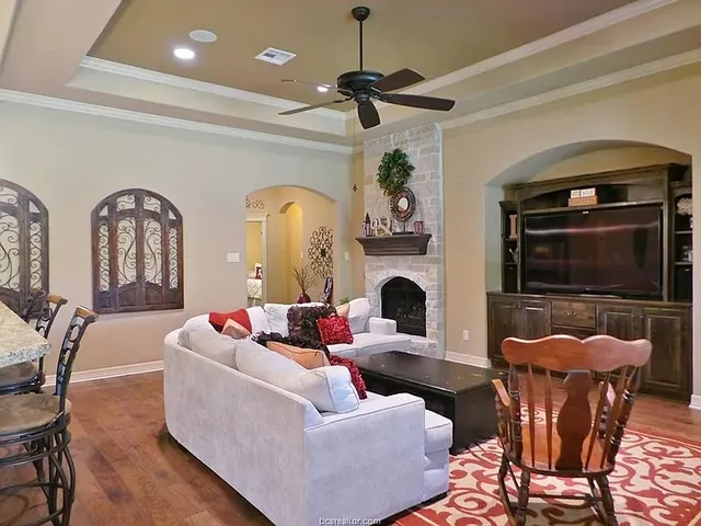 a living room with fireplace furniture and a window