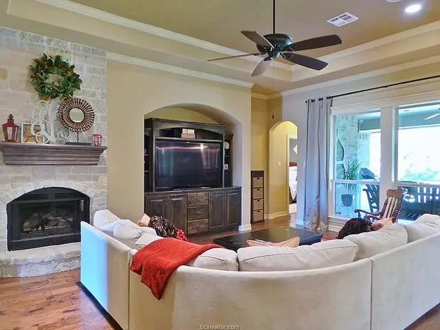 a living room with furniture and a fireplace