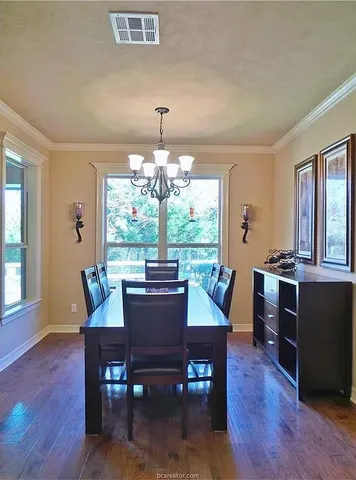 a dining room with furniture window and wooden floor