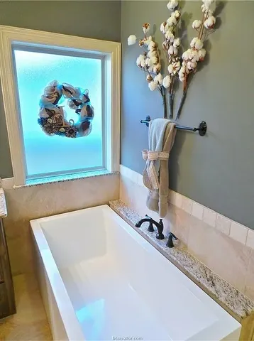 a white bath tub sitting in a bathroom