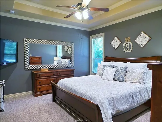 a bedroom with a bed and a chandelier