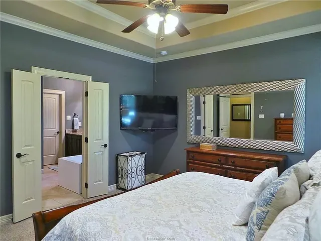 a bedroom with a bed and a chandelier