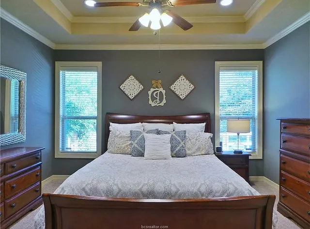 a bedroom with a large bed and a window