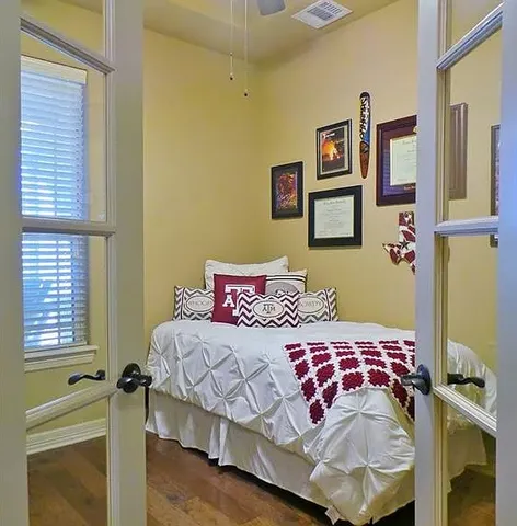 a bedroom with a bed and wooden floor