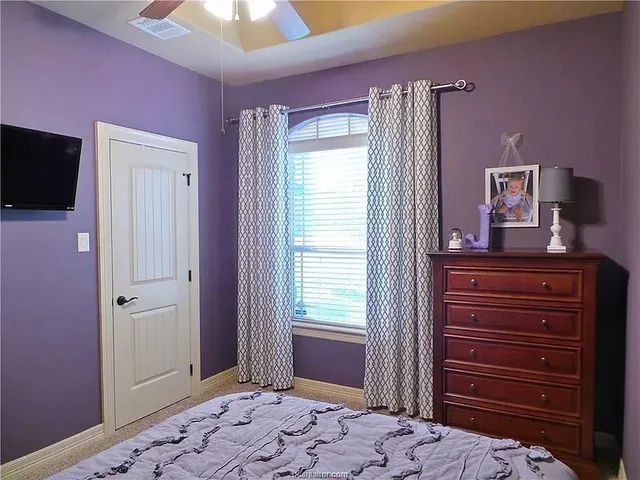 a bedroom with a bed and a dresser