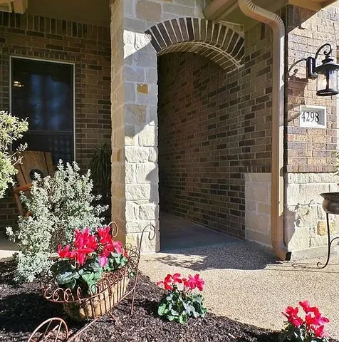 a view of a house with a flower garden