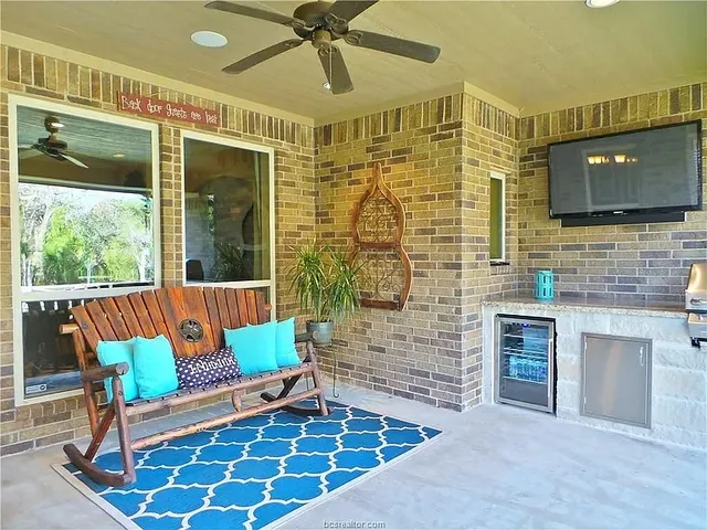 a porch with a table and chairs
