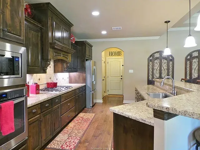 a kitchen with lots of counter space and sink