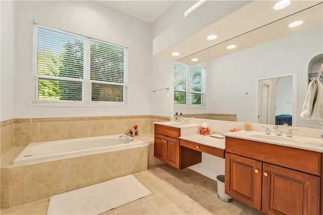 a bathroom with a tub sink and a window