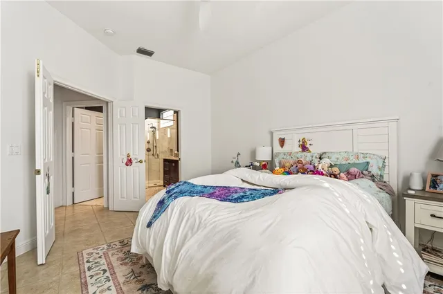 a bedroom with a bed and a painting on the wall