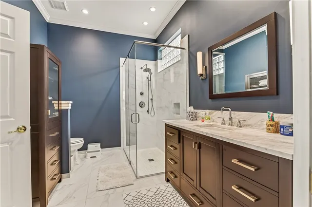 a spacious bathroom with a double vanity sink a mirror and a shower